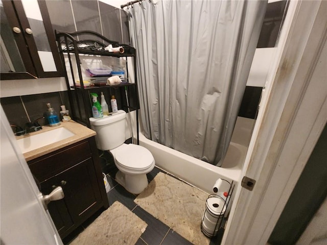 full bathroom with tile patterned flooring, vanity, toilet, and shower / bath combo with shower curtain