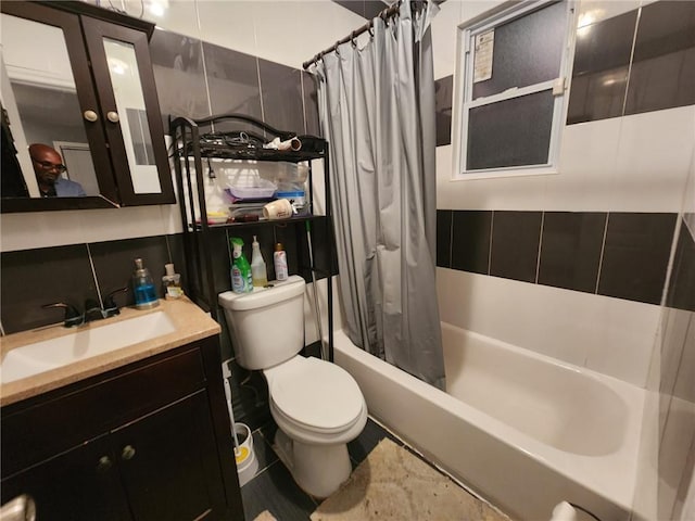 full bathroom featuring backsplash, tile walls, toilet, vanity, and shower / tub combo