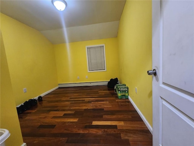 empty room featuring lofted ceiling, a baseboard radiator, and dark wood-type flooring