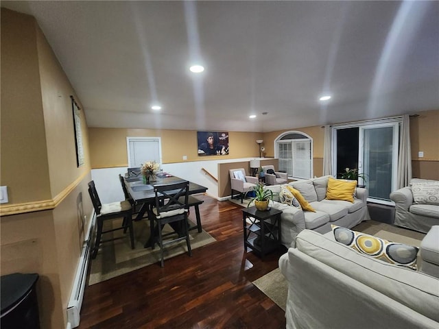 living room with dark wood-type flooring and a baseboard heating unit