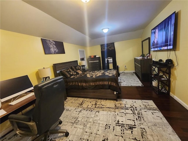 bedroom featuring lofted ceiling and hardwood / wood-style flooring