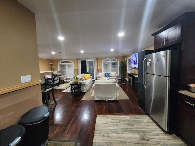 kitchen featuring stainless steel fridge and dark hardwood / wood-style flooring