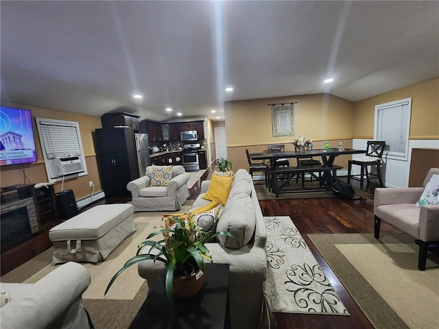 living room with baseboard heating, cooling unit, and dark wood-type flooring