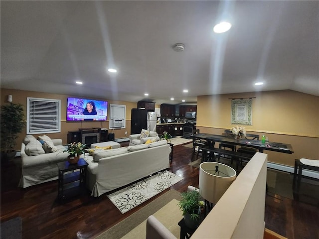 living room featuring dark hardwood / wood-style flooring and vaulted ceiling