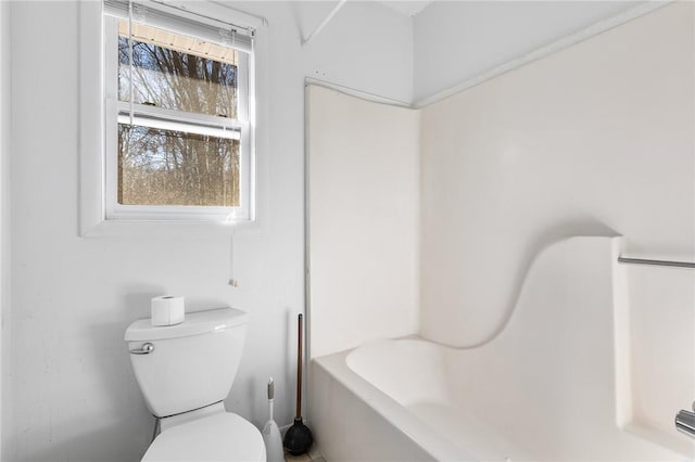 bathroom with toilet and a bath