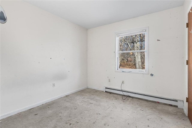 empty room with light carpet and a baseboard heating unit