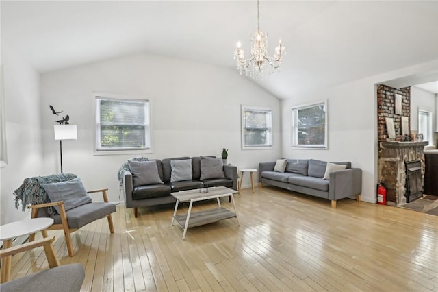 living room featuring light hardwood / wood-style floors, a brick fireplace, a wealth of natural light, and lofted ceiling