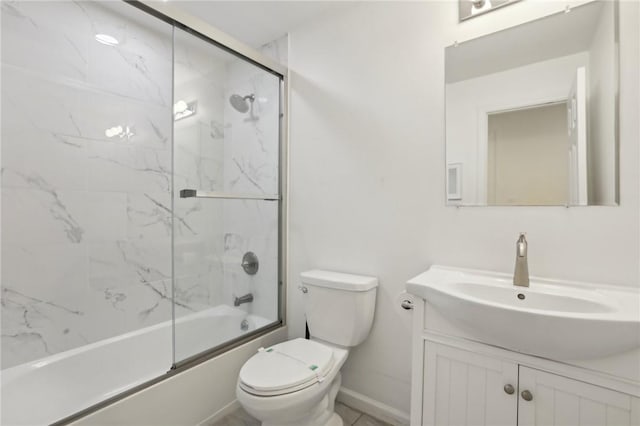 full bathroom with vanity, bath / shower combo with glass door, and toilet