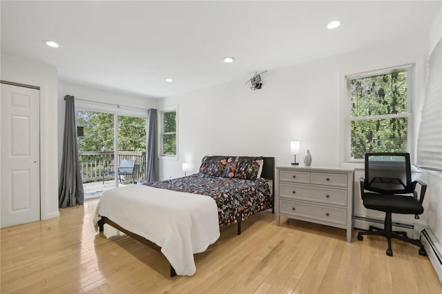 bedroom featuring light hardwood / wood-style floors, access to outside, and a baseboard radiator