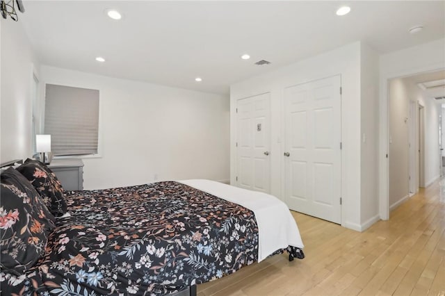 bedroom featuring light wood-type flooring and a closet