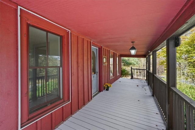 wooden terrace featuring covered porch