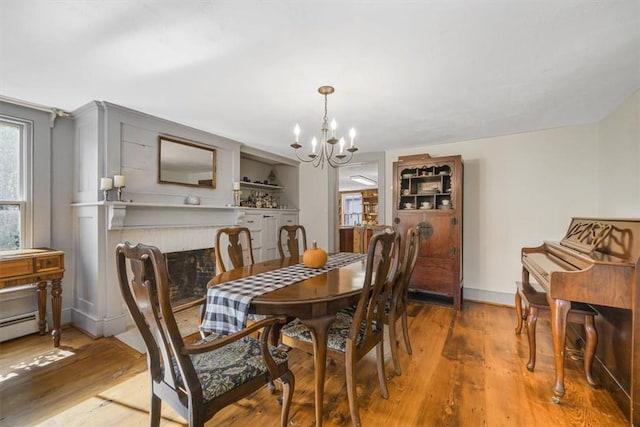 dining space featuring hardwood / wood-style floors and a notable chandelier