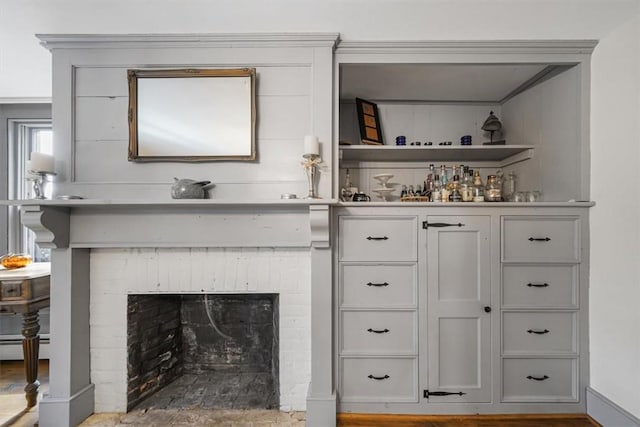 bar with a fireplace and a baseboard heating unit