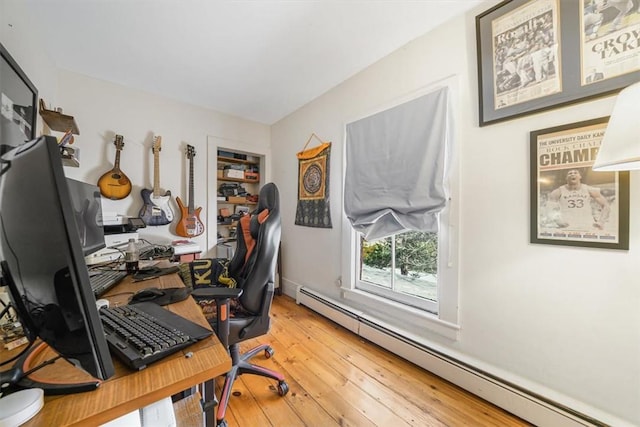 office space featuring wood-type flooring and baseboard heating