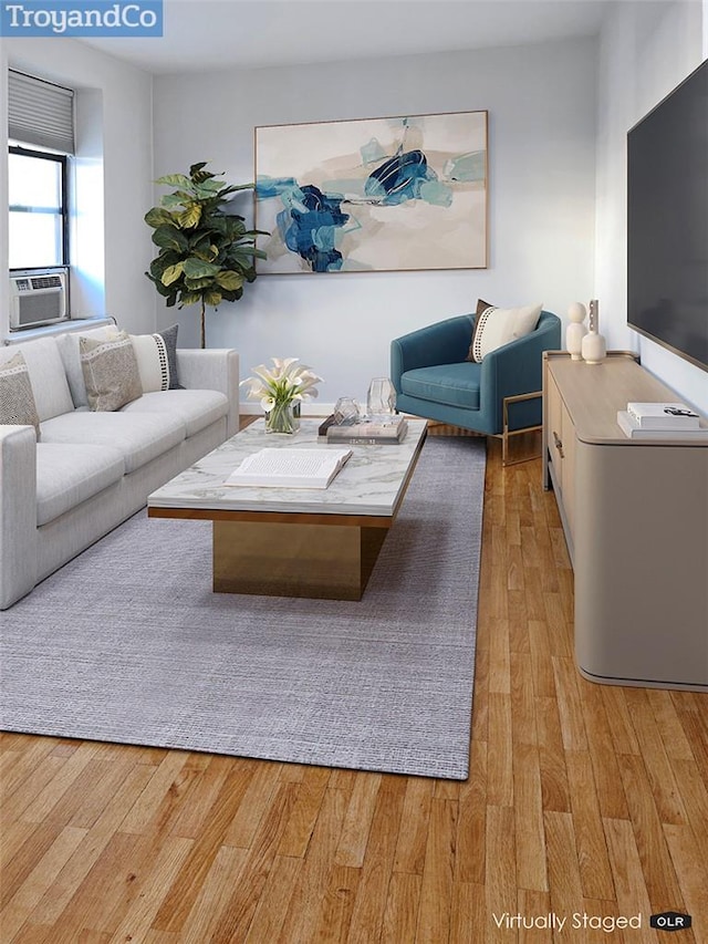 living room with cooling unit and light wood-type flooring