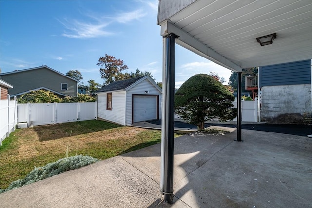 view of patio featuring an outbuilding and a garage