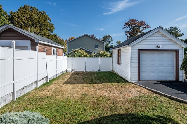 view of yard featuring a garage and an outbuilding