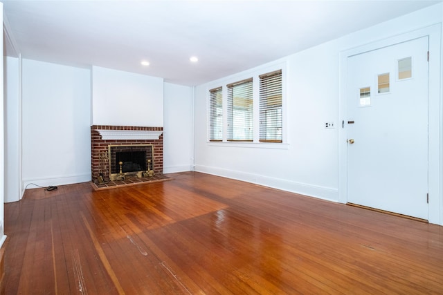 unfurnished living room with a fireplace and hardwood / wood-style floors