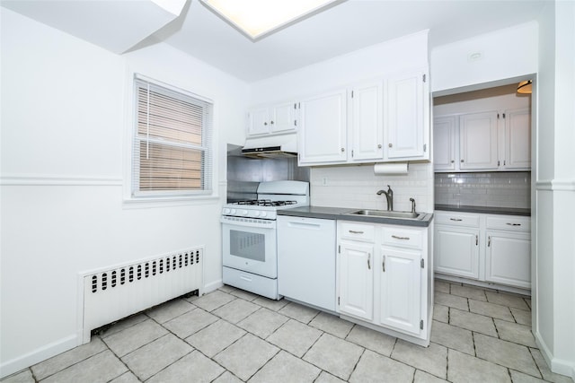 kitchen with white appliances, backsplash, radiator, sink, and white cabinetry