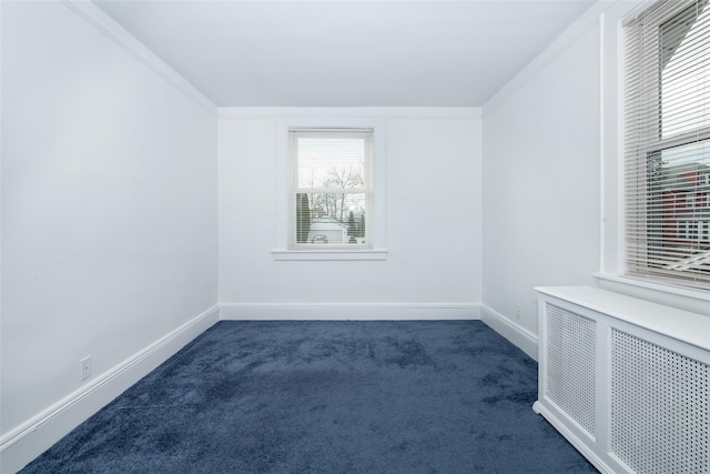 unfurnished room featuring dark colored carpet, radiator, and crown molding