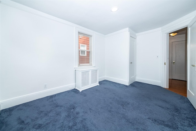 empty room with dark colored carpet