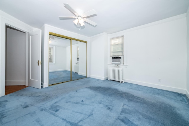 carpeted empty room featuring ceiling fan, cooling unit, radiator heating unit, and crown molding