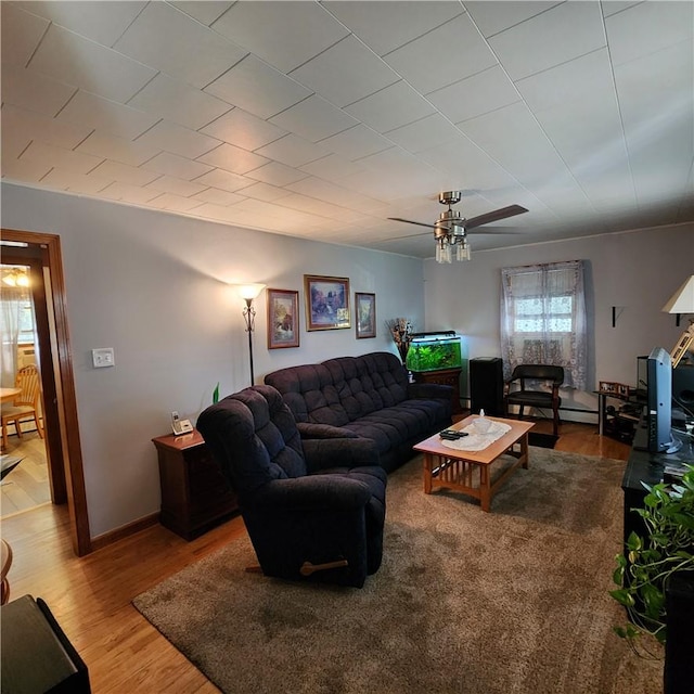 living room with light hardwood / wood-style floors and ceiling fan