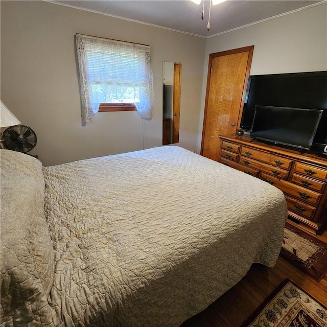 bedroom featuring hardwood / wood-style floors and ornamental molding