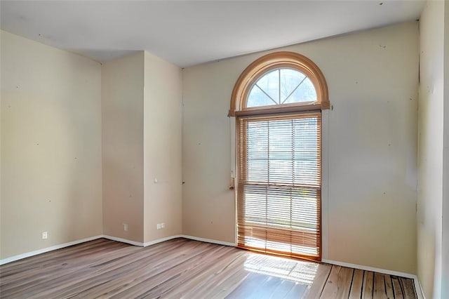 unfurnished room with light hardwood / wood-style flooring