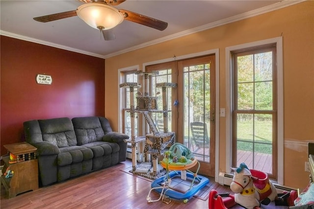 living room featuring hardwood / wood-style flooring, a baseboard radiator, ceiling fan, and ornamental molding