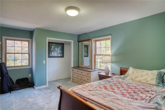 carpeted bedroom with multiple windows