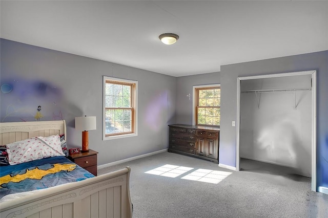 carpeted bedroom featuring multiple windows and a closet