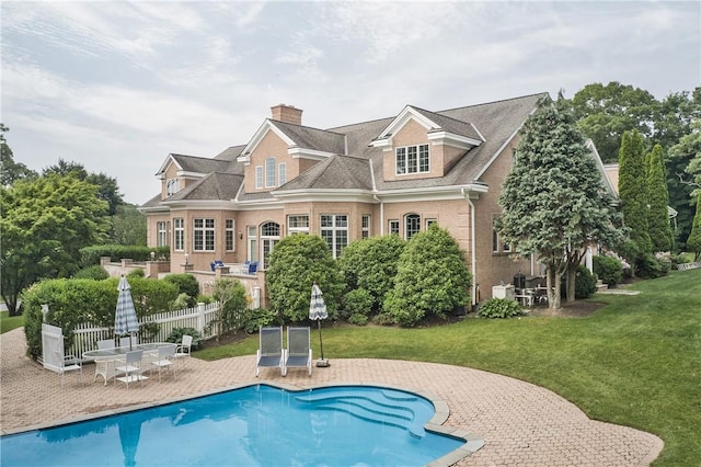 back of property featuring a yard and a patio