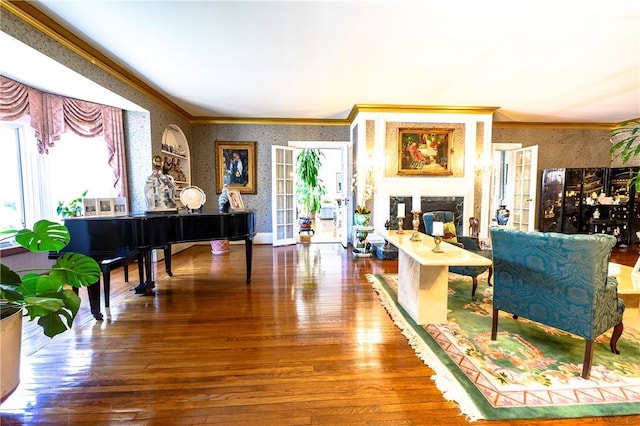 living room featuring wood-type flooring, french doors, and crown molding