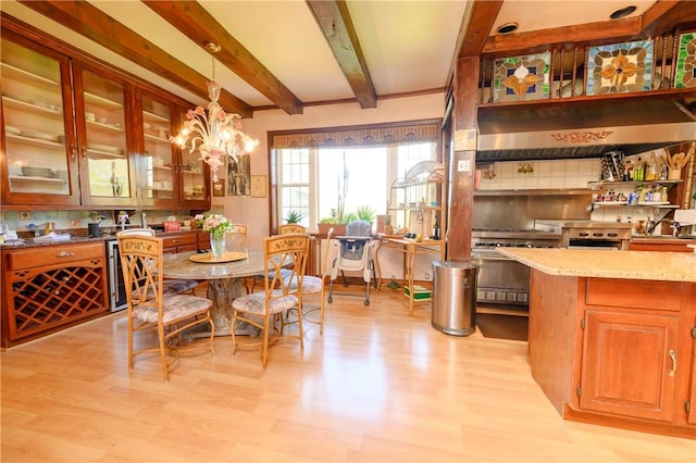 dining area with beamed ceiling, light hardwood / wood-style floors, and wine cooler