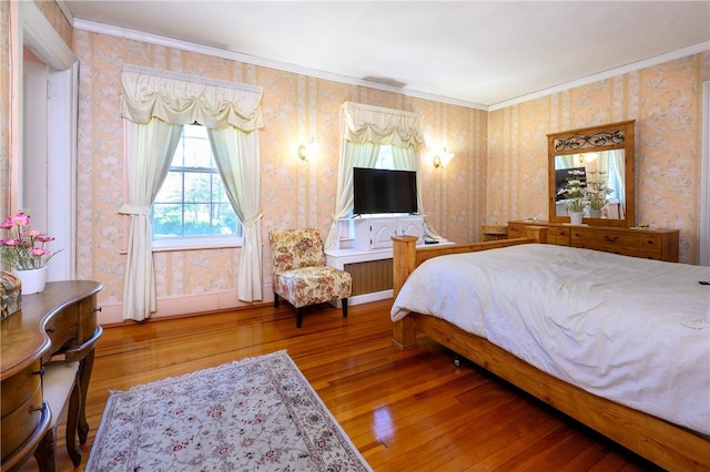 bedroom featuring hardwood / wood-style flooring and ornamental molding