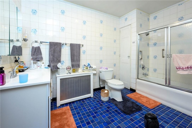 full bathroom with vanity, tile patterned floors, toilet, tile walls, and radiator heating unit