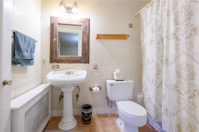 bathroom with tile patterned floors, tile walls, and walk in shower