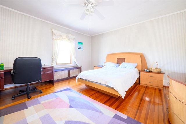 bedroom with ceiling fan, light wood-type flooring, and ornamental molding