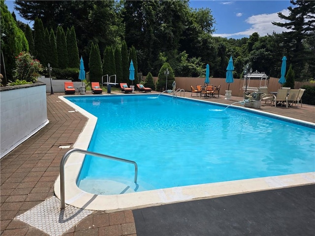 view of swimming pool with a patio area