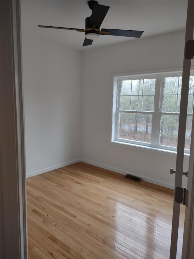 spare room with ceiling fan and light hardwood / wood-style flooring