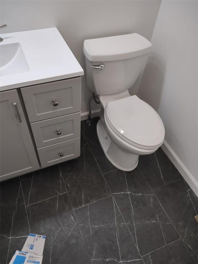 bathroom featuring vanity and toilet