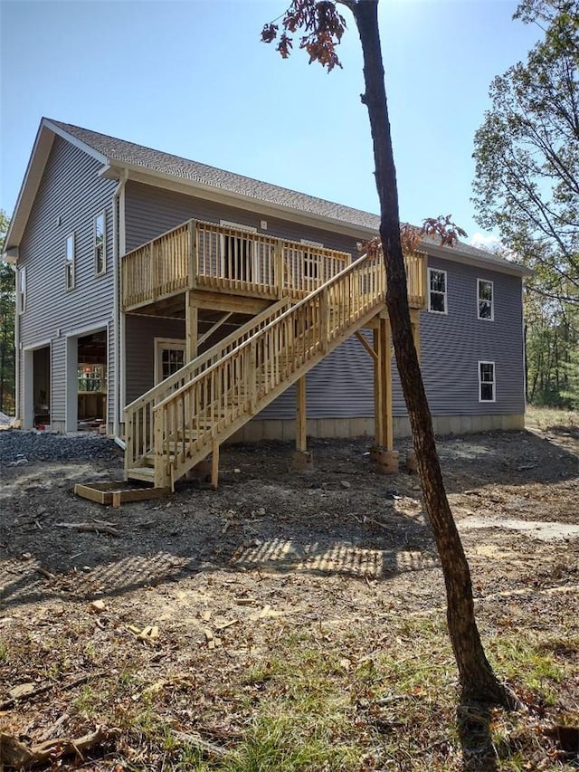 back of property featuring a wooden deck