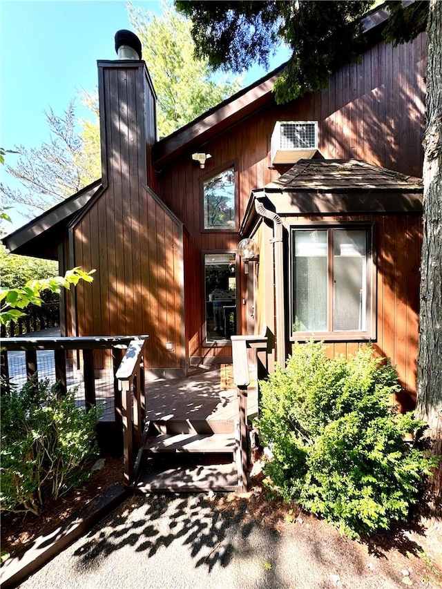 rear view of house featuring a wooden deck