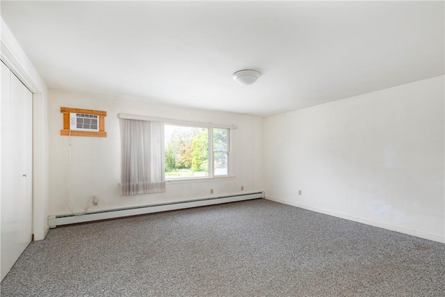 carpeted spare room with a wall mounted AC and baseboard heating