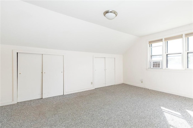 bonus room featuring carpet and vaulted ceiling