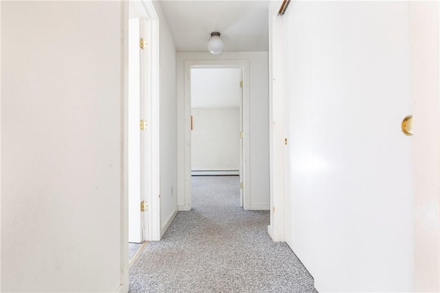 hall featuring light colored carpet and baseboard heating