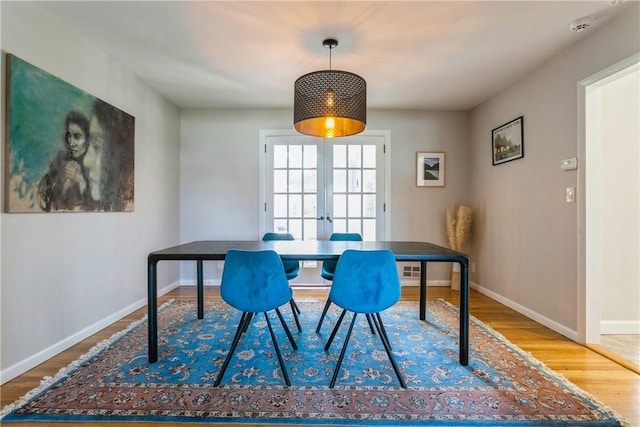 dining space with hardwood / wood-style floors