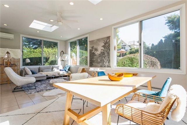 sunroom / solarium with a skylight, a wall mounted AC, a healthy amount of sunlight, and ceiling fan