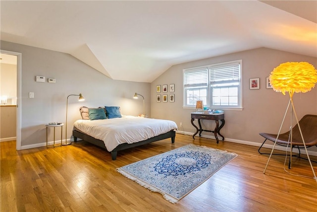 bedroom featuring vaulted ceiling and hardwood / wood-style flooring